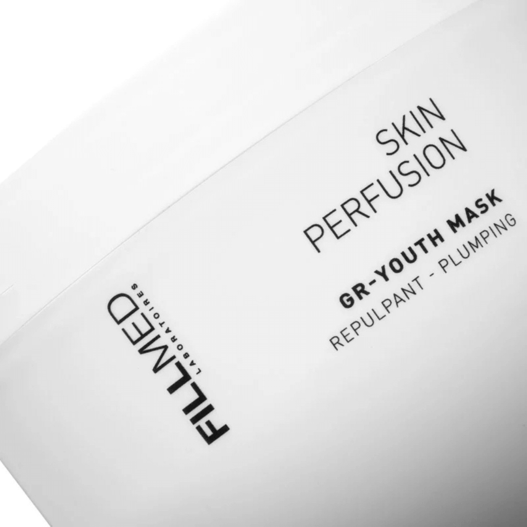Close-up of white jar labeled Fillmed Skin Perfusion GR-Youth Mask, plumping mask for dehydrated and tired skin.