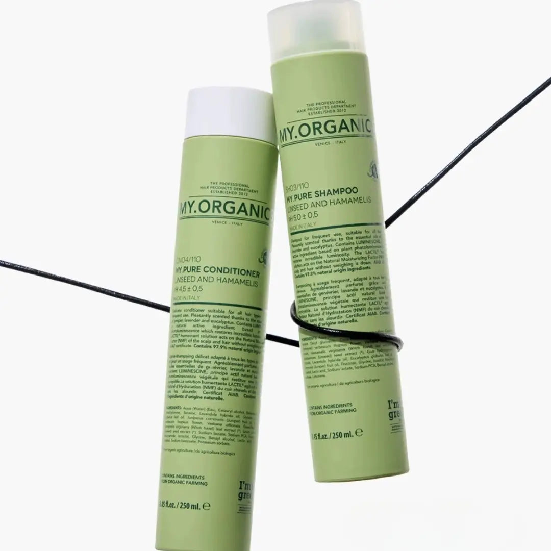 My Organics My Pure Shampoo and Conditioner bottles intertwined with a black cord, green bottles for gentle and frequent hair care.