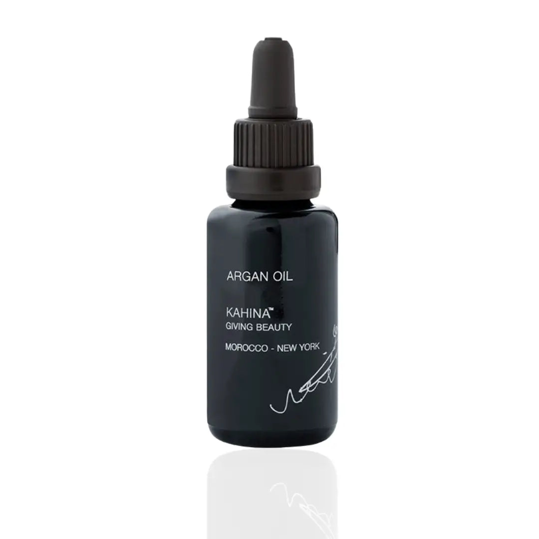 Kahina Argan Oil in a dark 30ml bottle with a pump, emphasizing its organic, fair-trade qualities and versatile use for skin, hair, and body care.
